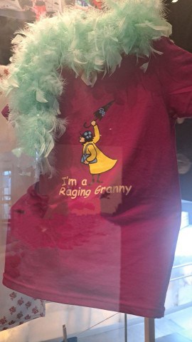 A Raging Grannies  T-Shirt and feather boa on display in the Inspiring Cahnge exhibit at the CMHR