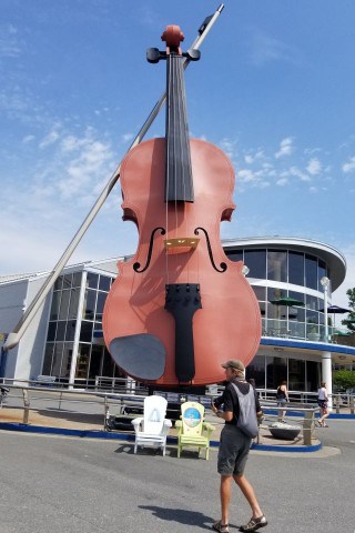 Distractions like random people detract from travel photos of toursit attractions like the World's Largest Fiddle