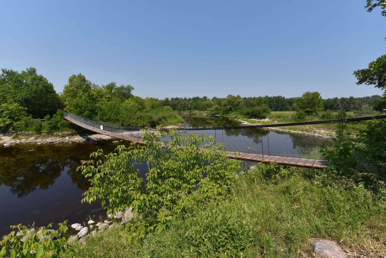 Landmarks like the Senkiw Swinging Bridge make the Crow Wing Trail pilgrimage route one of top sections of the Trans Canada Trail in Manitoba Canada.
