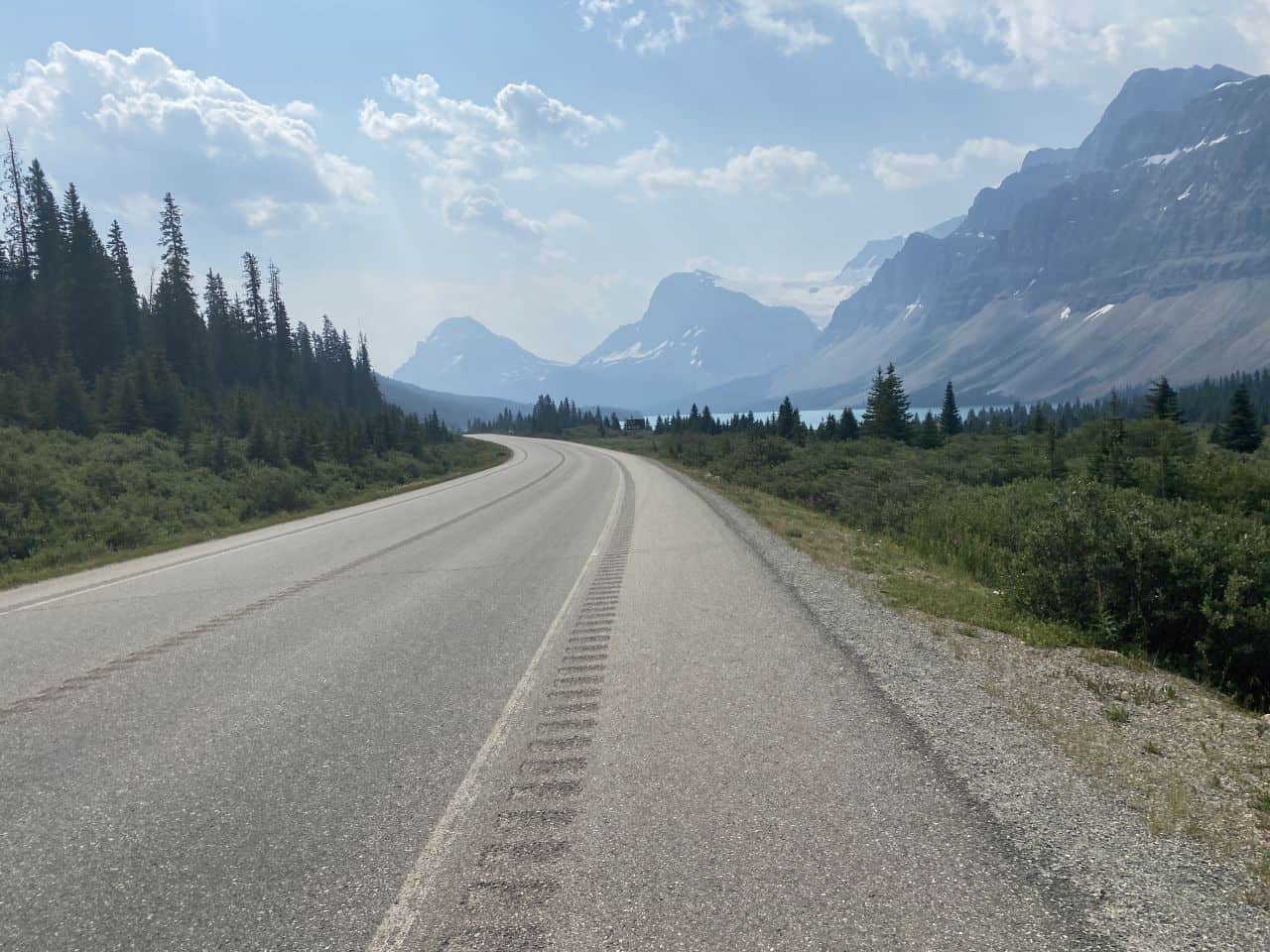 Not a soul on the road as we ride our bikes  along the Icefields Parkway towards Bow Lake in Banff National Park, Alberta, Canada.
