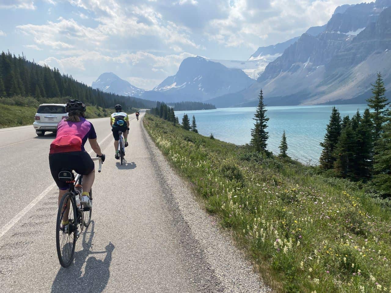 Cycling on the Icefields Parkway in Banff National Park, Alberta, Canada past Bow Lake's turquoise water is a stunning location