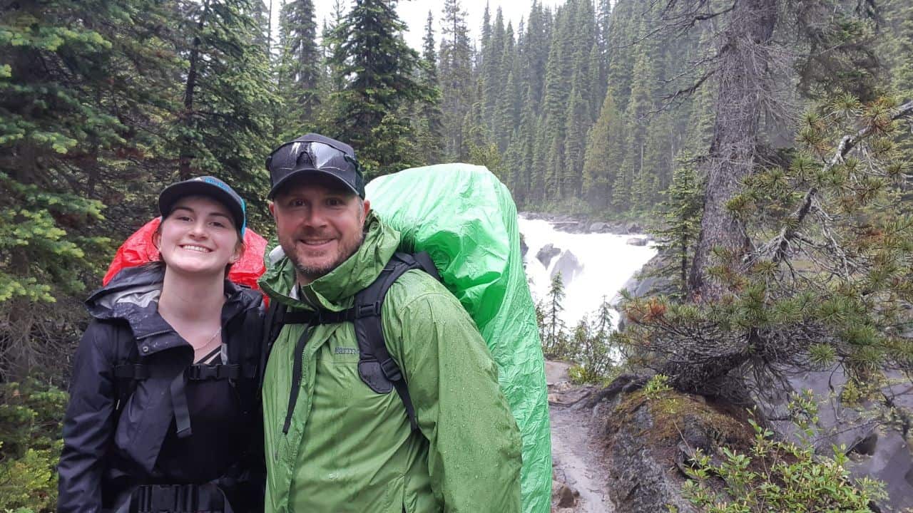 All smiles hiking in the rain to Twin Falls Campground in Yoho National Park BC Canada