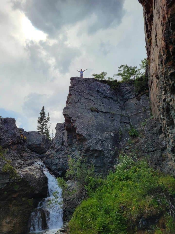 Hiking and climbing to a waterfall viewing point over looking North Drywood Falls near Pincher Creek.