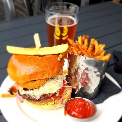 A burger, fries and craft beer to enjoy on the patio during a hot summer day in Field BC in the Canadian Rockies