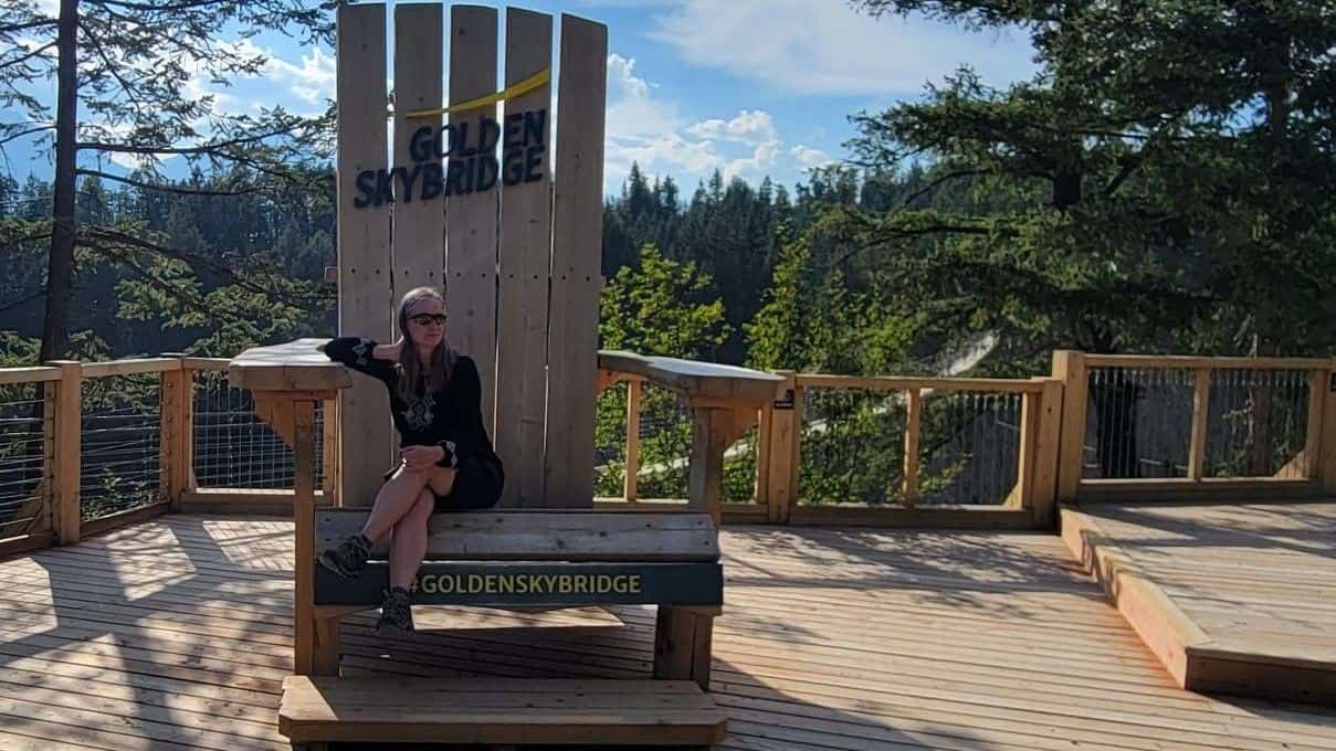 Sitting in a big chair enjoying the canyon and mountain views at Golden Skybridge in Golden BC Canada