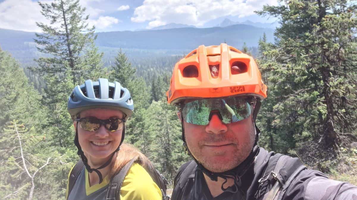A mountain biking selfie break to capture the bikers smiles and the sweeping valley views in Golden BC Canada