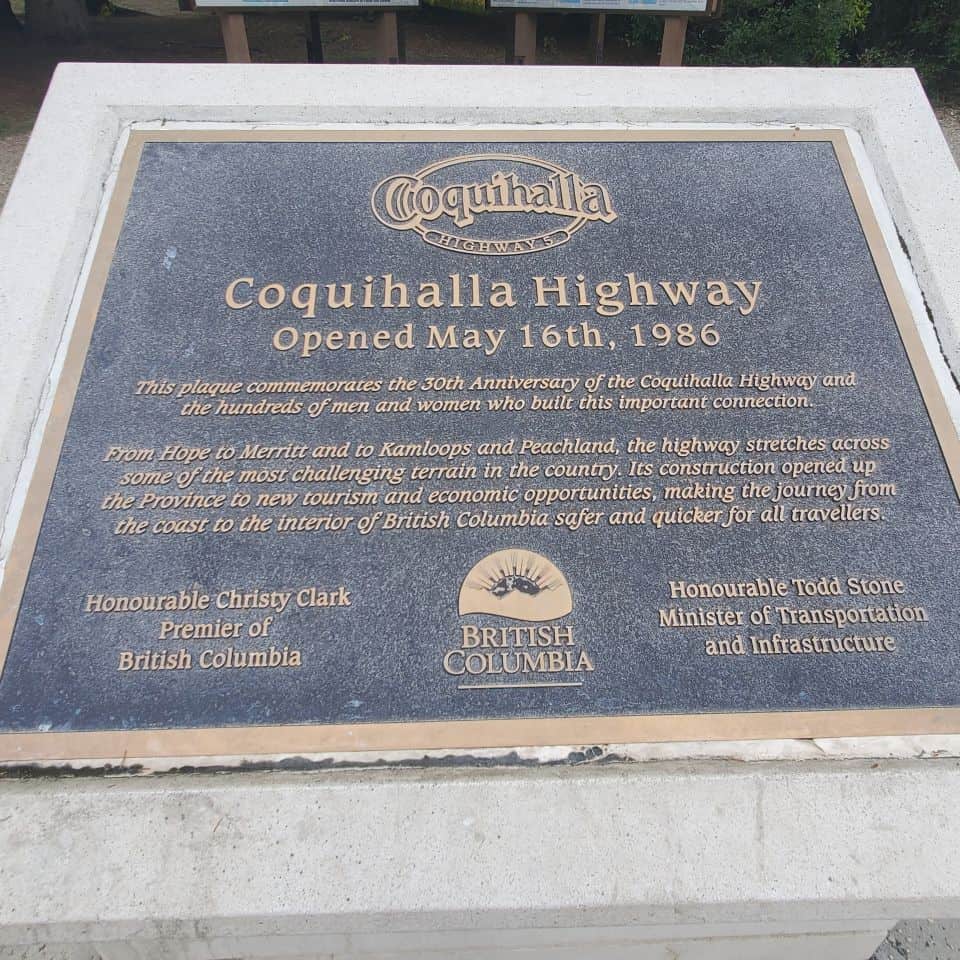 Plaque about the Coquihalla Highway. At Britton Creek Rest Area. Picnic tables. Bathrooms. Space to walk a dog.