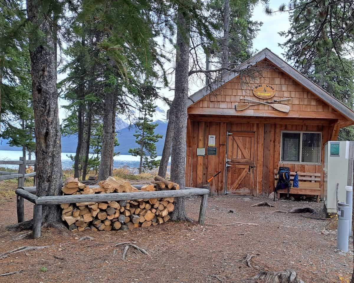 The cookshack, food storage lockers and firewood supply at Hidden Cove Campground on Maligne Lake