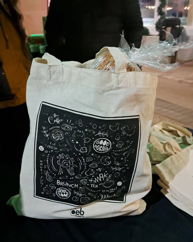 A grocery bag filled with OEB coffee, bread and farm fresh eggs. Proceeds support the Edmonton YWCA on 124 Street.