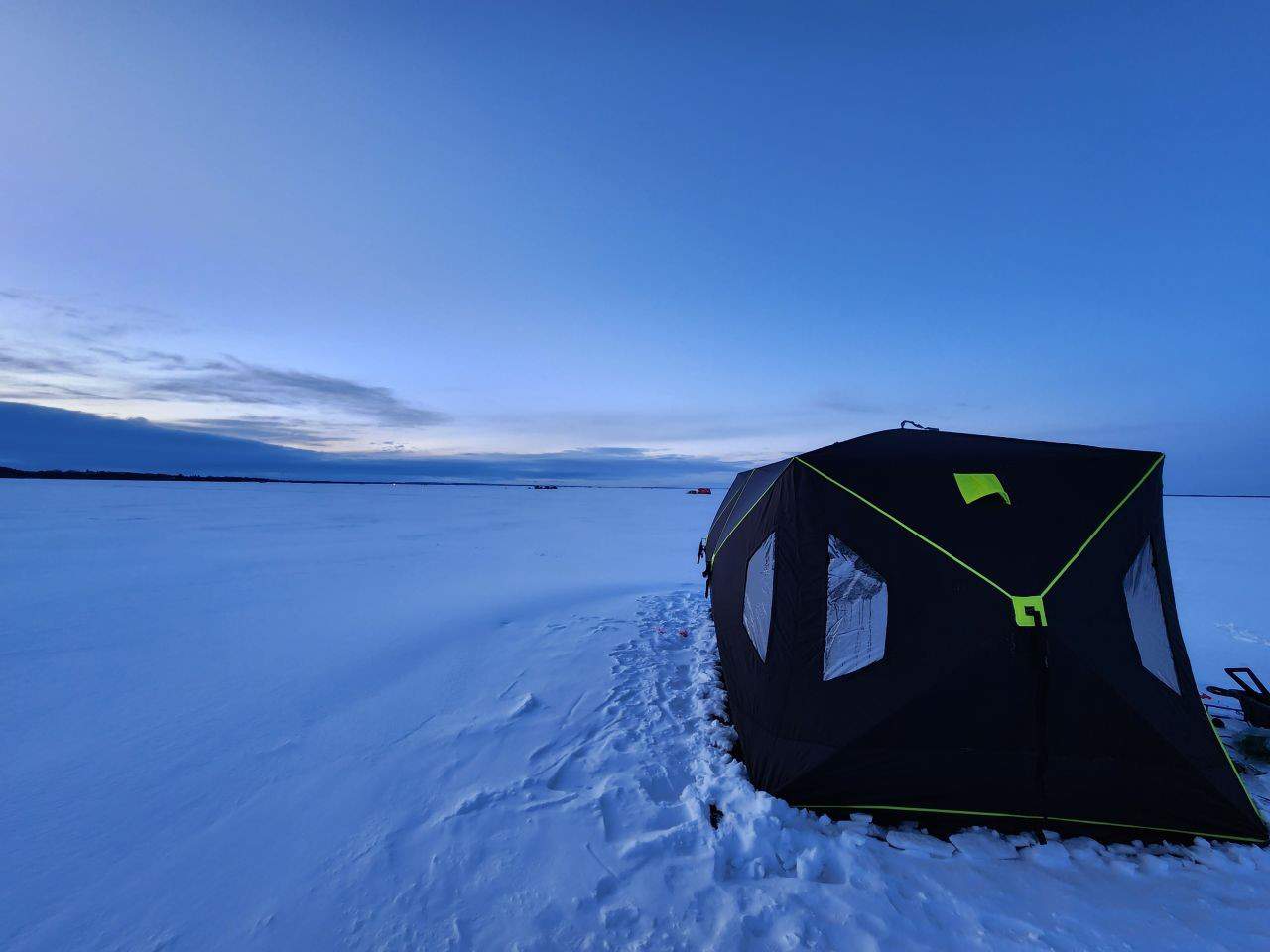 Ice fishing on Buffalo Lake Alberta Canada. An ice hut will keep you out of the elements to enjoy a day of ice fishing