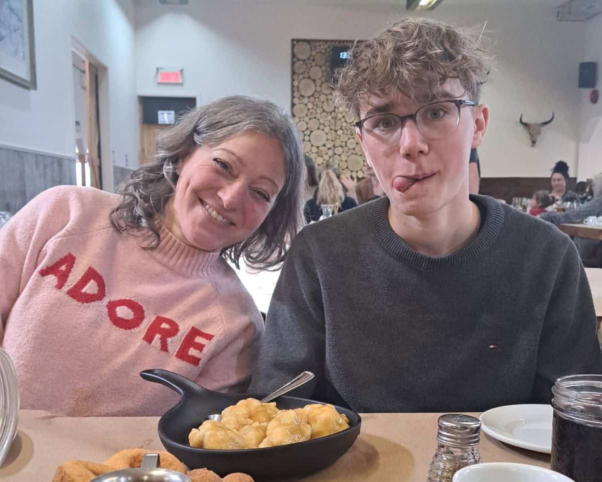 A happy family enjoys a hearty French Canadian meal at a maple syrup sugar shack at Mont Gregoire a short drive south of Montreal, Quebec.