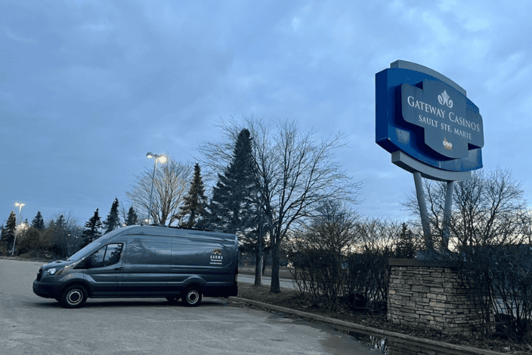 A camper van parked in the parking lot of the Gateway Casino in Sault Ste. Marie at sundown.