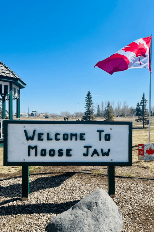 Canadian flag blows in the wind over a blue sky at the Moose Jaw Welcome Centre, Moose Jaw, Saskatchewan.