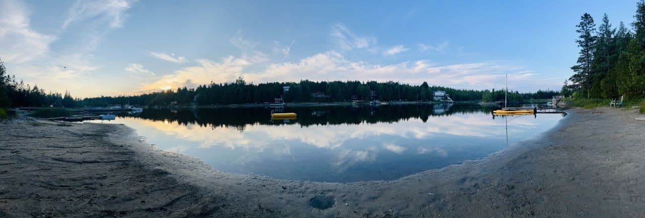 Panoramic view from the sandy beach at dusk.