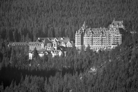 The Fairmont Banff Springs Hotel offers panoramic views and a chilling ghost story of a bride who tragically fell to her death—her spirit still wanders the grand staircase.
