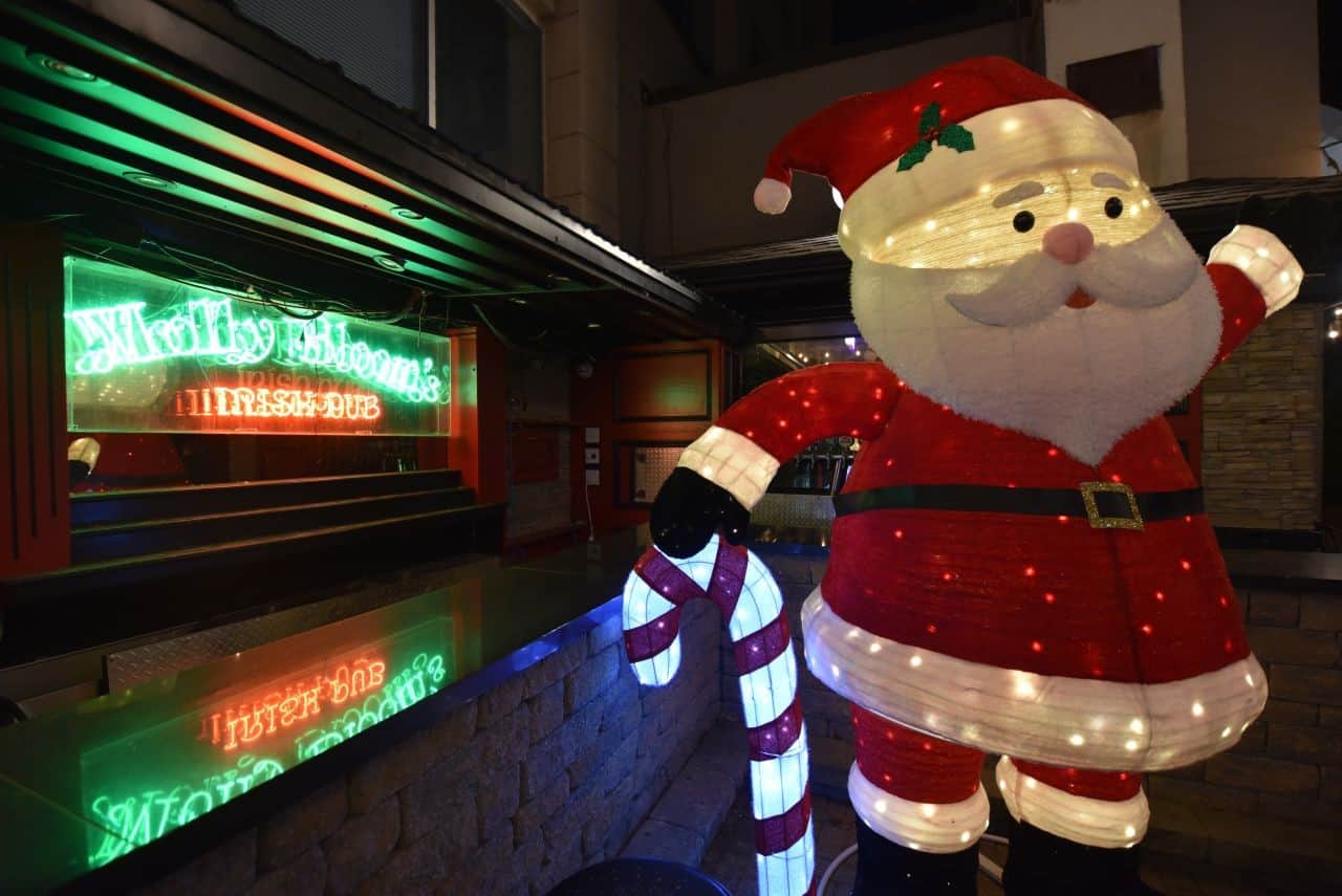 Viewers enjoy the CPKC Holiday Train's festive lights and music from the outdoor patio at Molly Bloom's Irish Pub in London, Ontario, making for an unforgettable experience during the CPKC Holiday Train Crosses Canada.