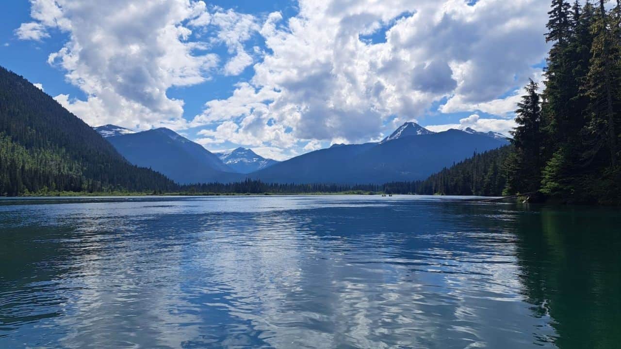 Looking across McLeary Lake towards rugged mountain peaks on the Bowron Lake Canoe Circuit in BC