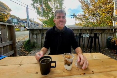 Enjoying coffee on The Battery Café’s sunny outdoor patio in St. John’s, Newfoundland, with harbour views and coastal charm — the perfect spot to relax after hiking the scenic North Head Trail.
