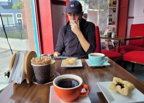 Enjoying a fresh strawberry tart and rich coffee at Memorial Café in downtown St. John’s, Newfoundland — the perfect spot to refuel after a classic city pub crawl adventure.