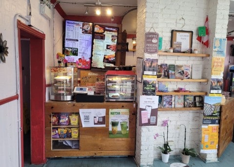 Step inside the cozy, eclectic interior of Memorial Café in downtown St. John’s, Newfoundland, and enjoy a welcoming atmosphere, comforting coffee, and locally inspired treats after exploring the city.