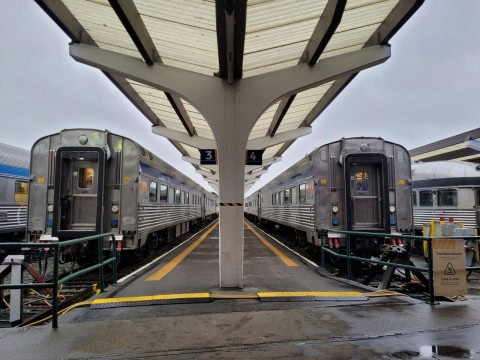 Pacific Central Station welcomes VIA Rail’s The Canadian passengers after a five-day winter journey, with city lights shimmering through coastal fog and marking the culmination of a transcontinental train adventure.