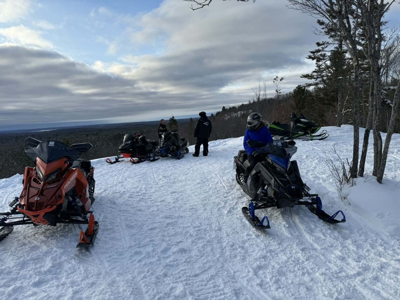 Snowmobiles parked at Redbridge Lookout along the OFSC Snow Explorers Route near North Bay Ontario