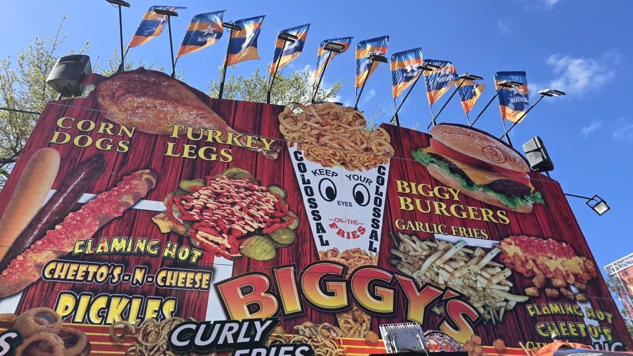 Biggy’s food stand sign at the Houston Livestock Show and Rodeo midway showing a large variety of fair food options in Texas