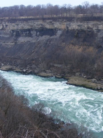 Scenic view of the Niagara River from an overlook along the Niagara River Recreational Trail in Ontario, Canada, featuring river landscapes, shoreline greenery, and peaceful viewpoints for hikers and cyclists.
