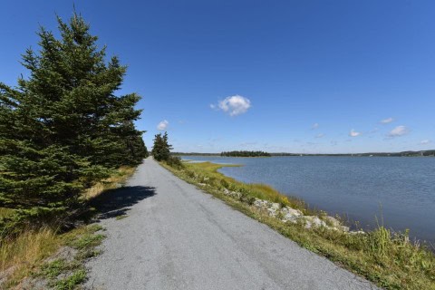 A scenic coastal section of the Way of Stella Maris in Nova Scotia, where pilgrims walk beside the Atlantic Ocean, enjoying peaceful views, sea air, and reflective long-distance hiking experiences.