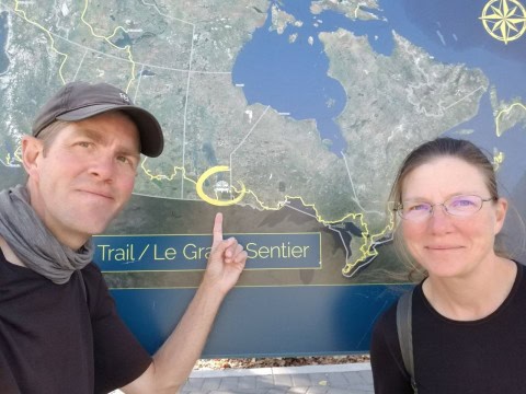 Standing beside a Trans Canada Trail map while planning a cycling adventure. The national trail network spans thousands of kilometres and connects communities, landscapes, and outdoor experiences across Canada.