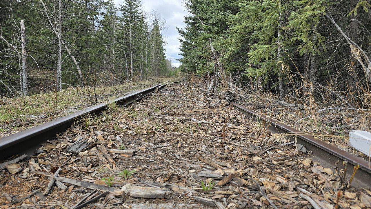 Old out of commission train tracks lead you to the old ghost town of Nordegg Alberta Canada