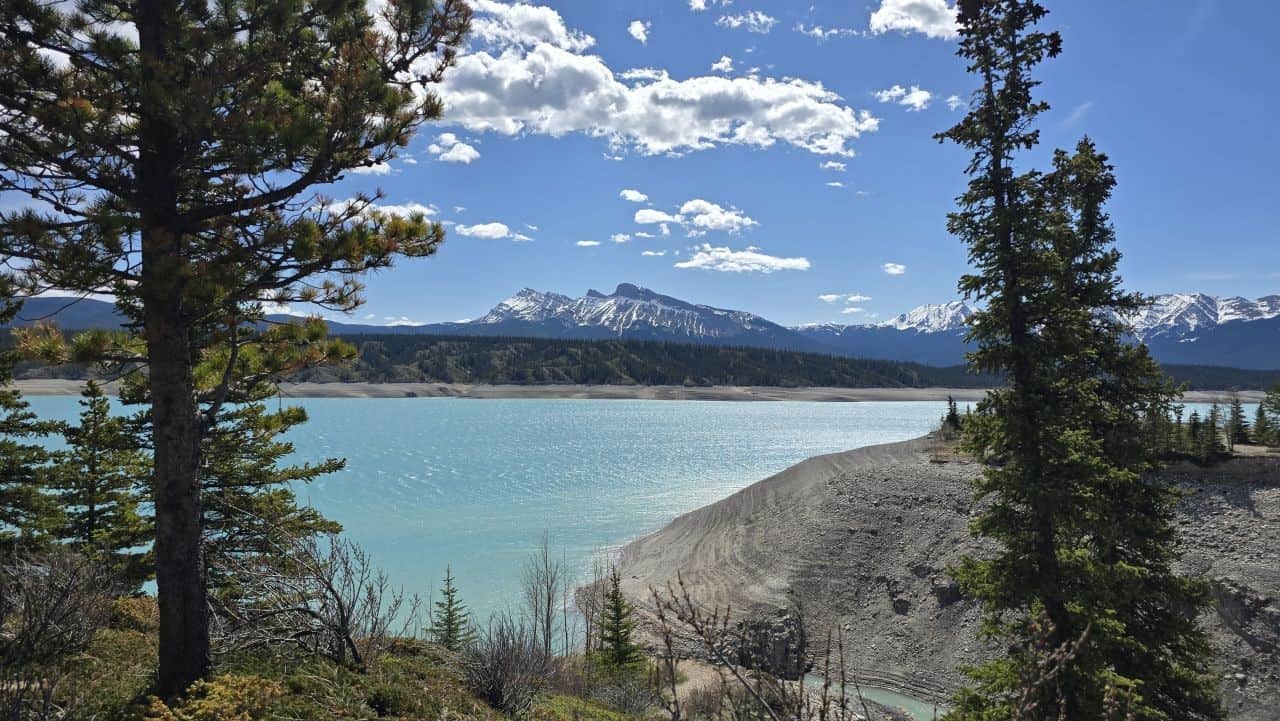 Hiking the Abraham Lake Shoreline Trail offers stunning blue water and mountain views in Alberta Canada