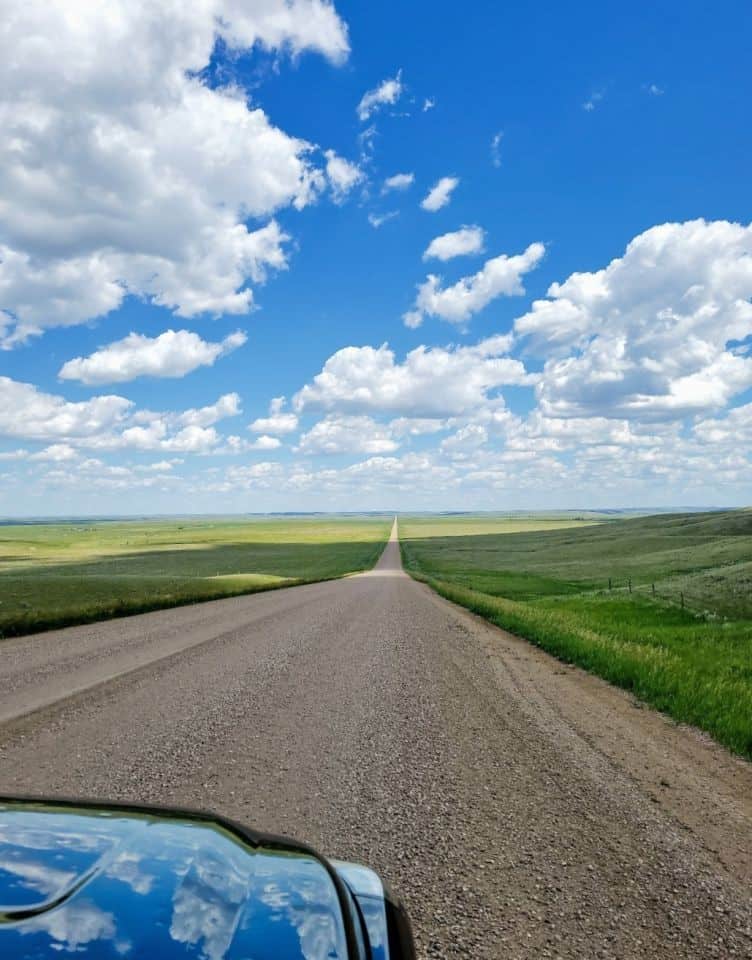 Prairie road trips offer unique endless views of the road ahead stretching for miles.