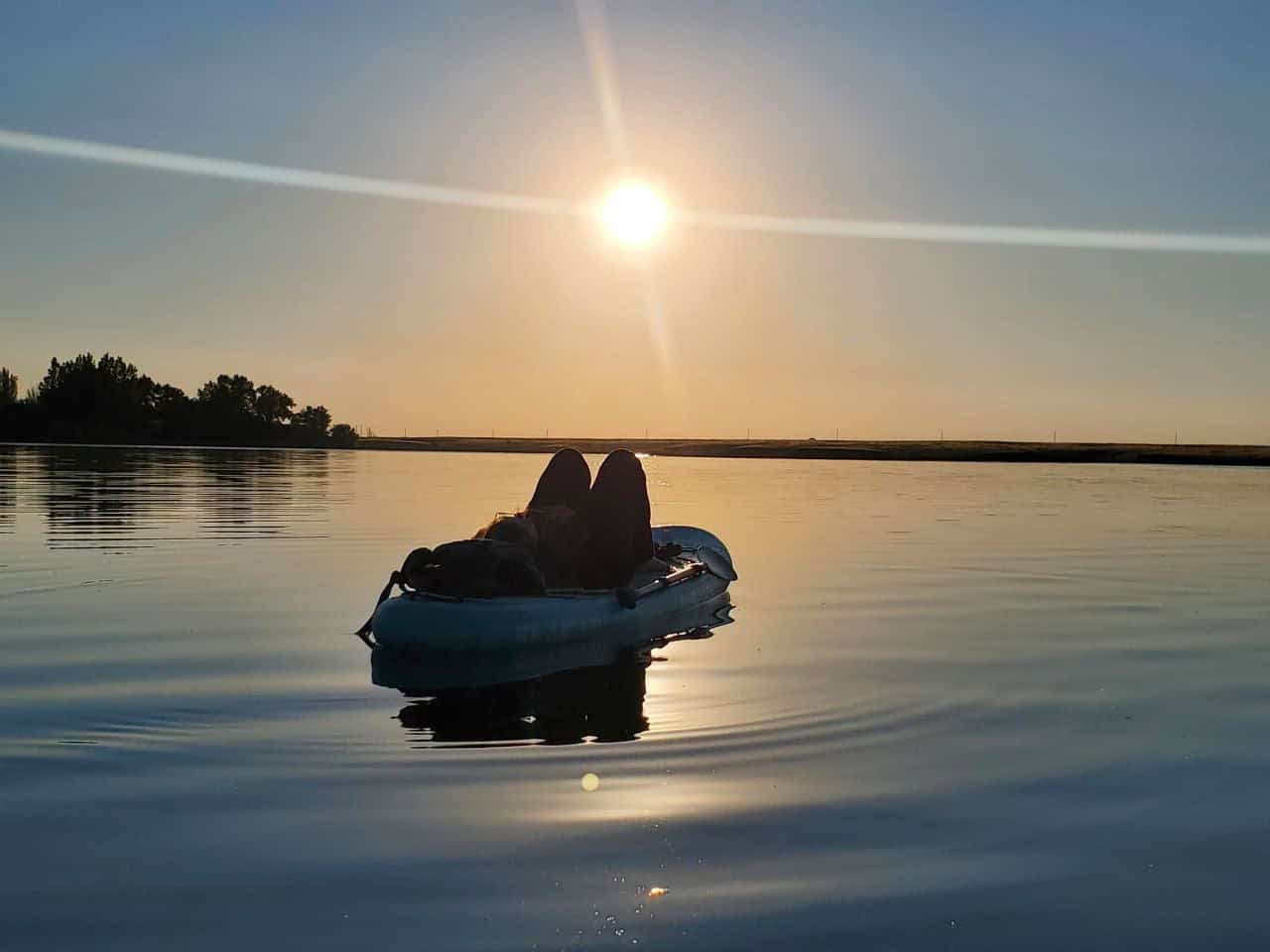 Woman paddleboarding on Rattlesnake Lake in southeast Alberta Canada