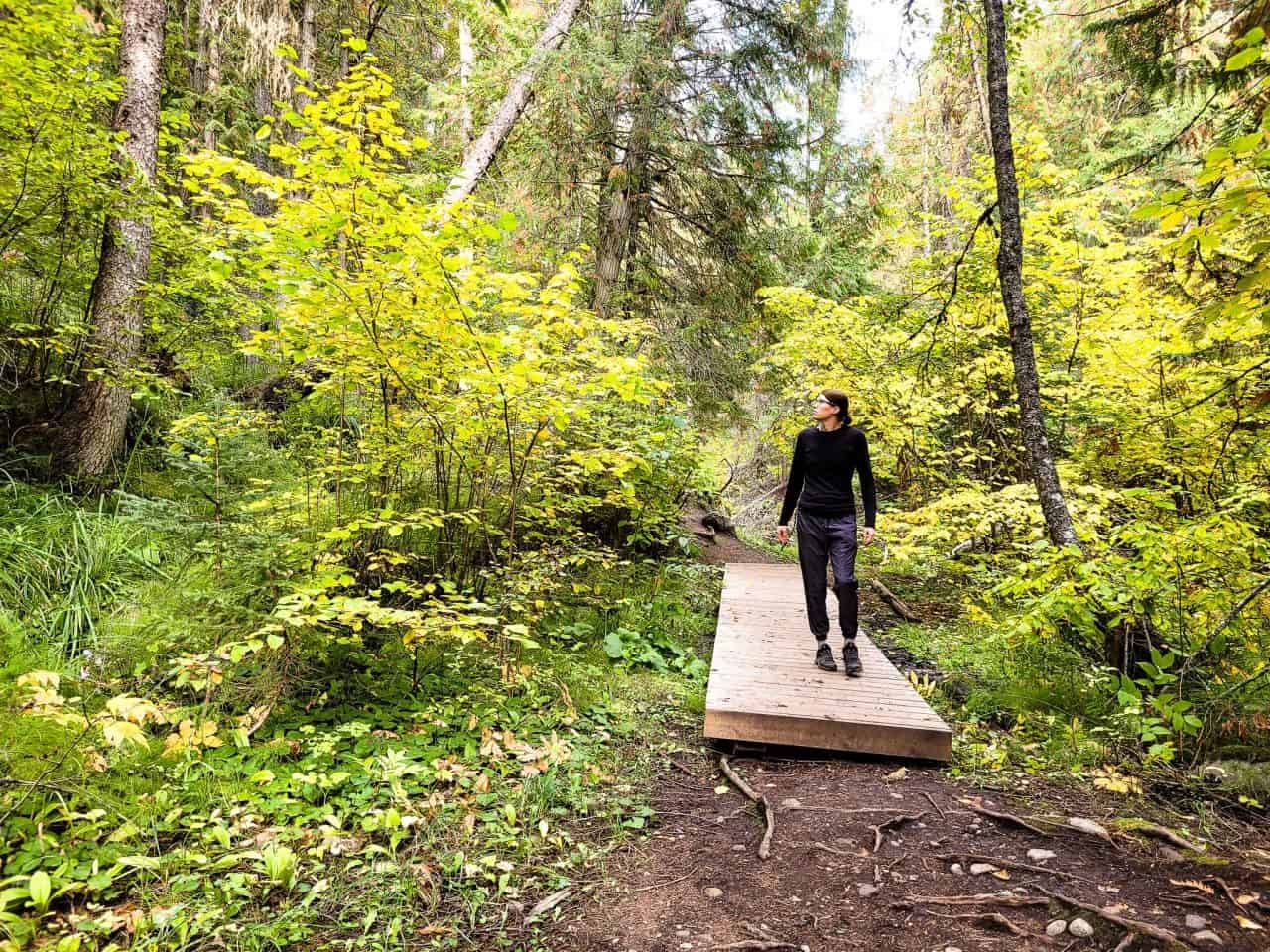 Girl walking over a wooden bridge at BX Creek trail