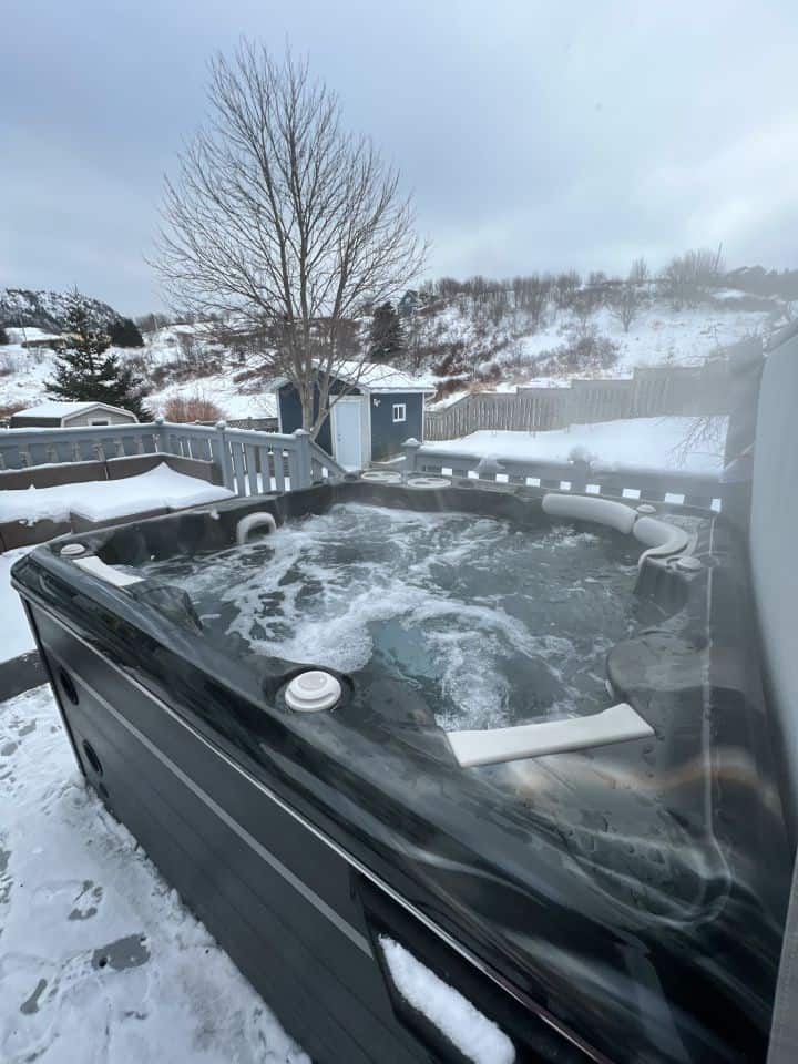 Hot tubbing near Quidi Vidi brewery Newfoundland is a fun Winter activity anytime of a vacation in Atlantic Canada.