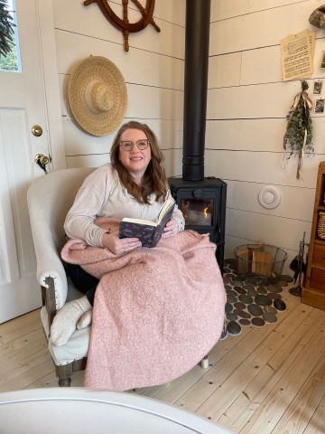 At the hut on the Atlantic Ocean in Colliers Newfoundland reading a book at the A Little Cup of Sea.