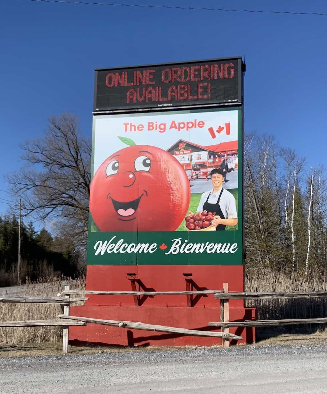 The Big Apple Road Sign Colborne Ontario - This Big Apple roadside sign welcomes and directs visitors to the Big Apple site in Colborne, Ontario Canada.