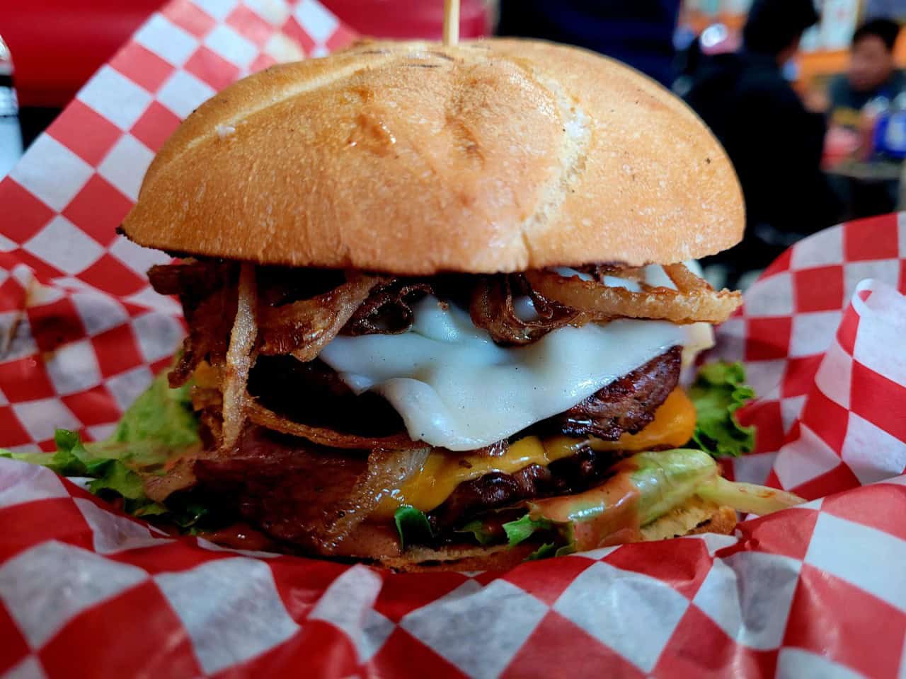 Famous Flipp'n Burger at Flipp'n Burgers Kensington - Calgary Alberta - This is the famous Flipp'n Burger at Flipp'n Burgers Kensington. Three meat patties, Swiss & Cheddar Cheese and Crunchy Onions on a huge Kaiser bun is one delicious burger.
Give them a try next time you are visiting Calgary, Alberta, Canada.
