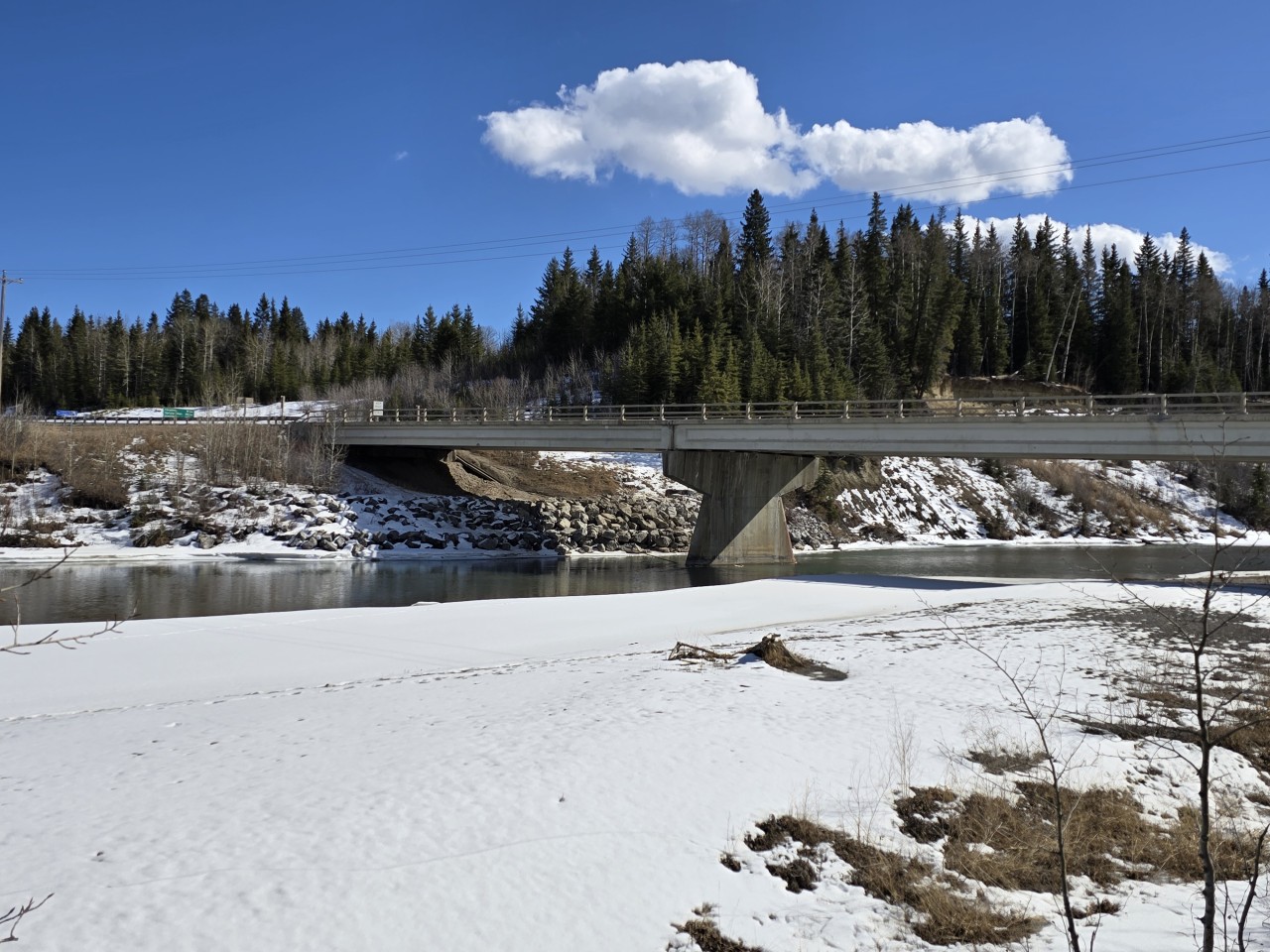 Clearwater River Bridge Alberta - Spring slowly releases its grip along the Clearwater River as ice melts and open water begins to return across the region.