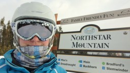 Standing at the Northstar Mountain Sign