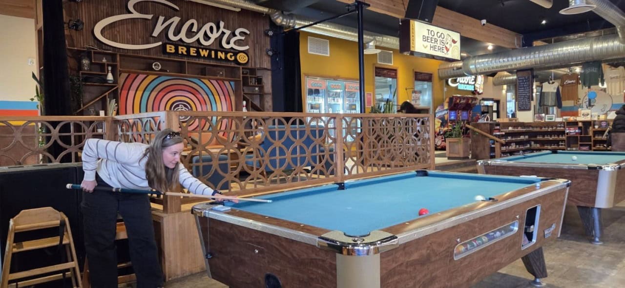 Cranbrook Billiards at Encore Brewing - Playing pool inside Encore Brewing Company, one of several games available alongside bowling, arcade games, and craft beer in Cranbrook BC.