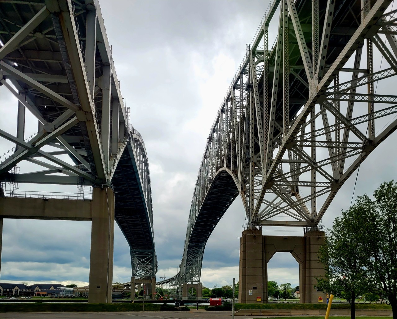 Blue W8ater Bridge between Canada and the USA  - Point Edward Ontario Canada  - In the 1920's with the popularity of the automobile booming, plans began for the Blue Water Bridge and were designed by a man known as 'America's Greatest Bridge Builder' named Ralph Modjeski.
On October 10th, 1938 the first span of the Blue Water Bridge was opened.
On July 22nd, 1997 the second span of the Blue Water Bridge opened. 
Built just 125 feet south of the original bridge to meet increased traffic and commercial demand.
