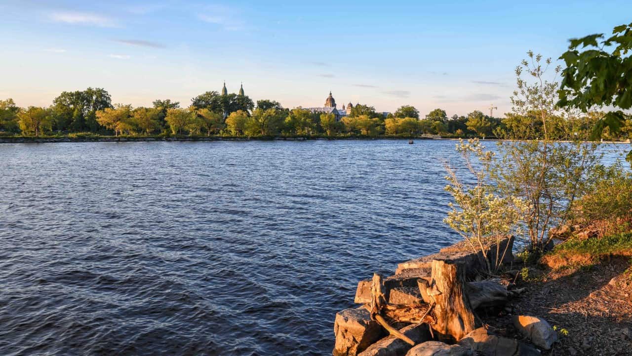 Warm-Evening-Sun - Golden hour hitting the Lachine shoreline hits different. As the sun dips low, an incredible orange glow lights up the stone facade of Collège Sainte-Anne and catches the twin copper spires of Paroisse Saints-Anges. Watching the warmth reflect off the water from the quiet paths of Parc René-Lévesque is absolute magic. Nature and historic architecture in perfect harmony