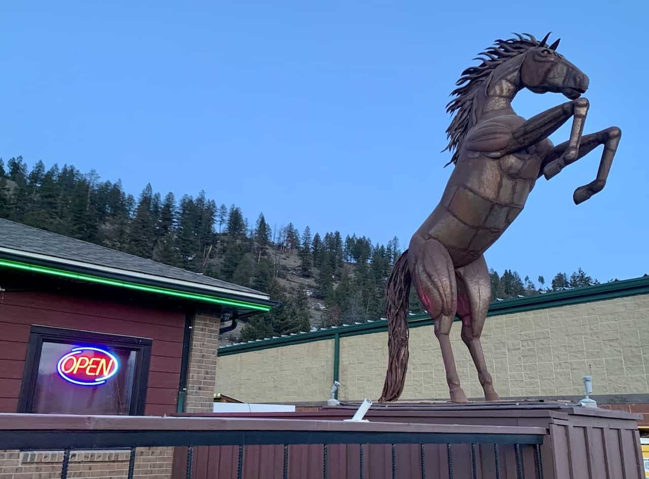 Horse Statue in front of Horsethief Creek Pub and Eatery - The horse statue and lit up OPEN sign in front of the Horsethief Creek Pub & Eatery welcome visitors to the best restaurant in  Radium Hot Springs, British Columbia, Canada.