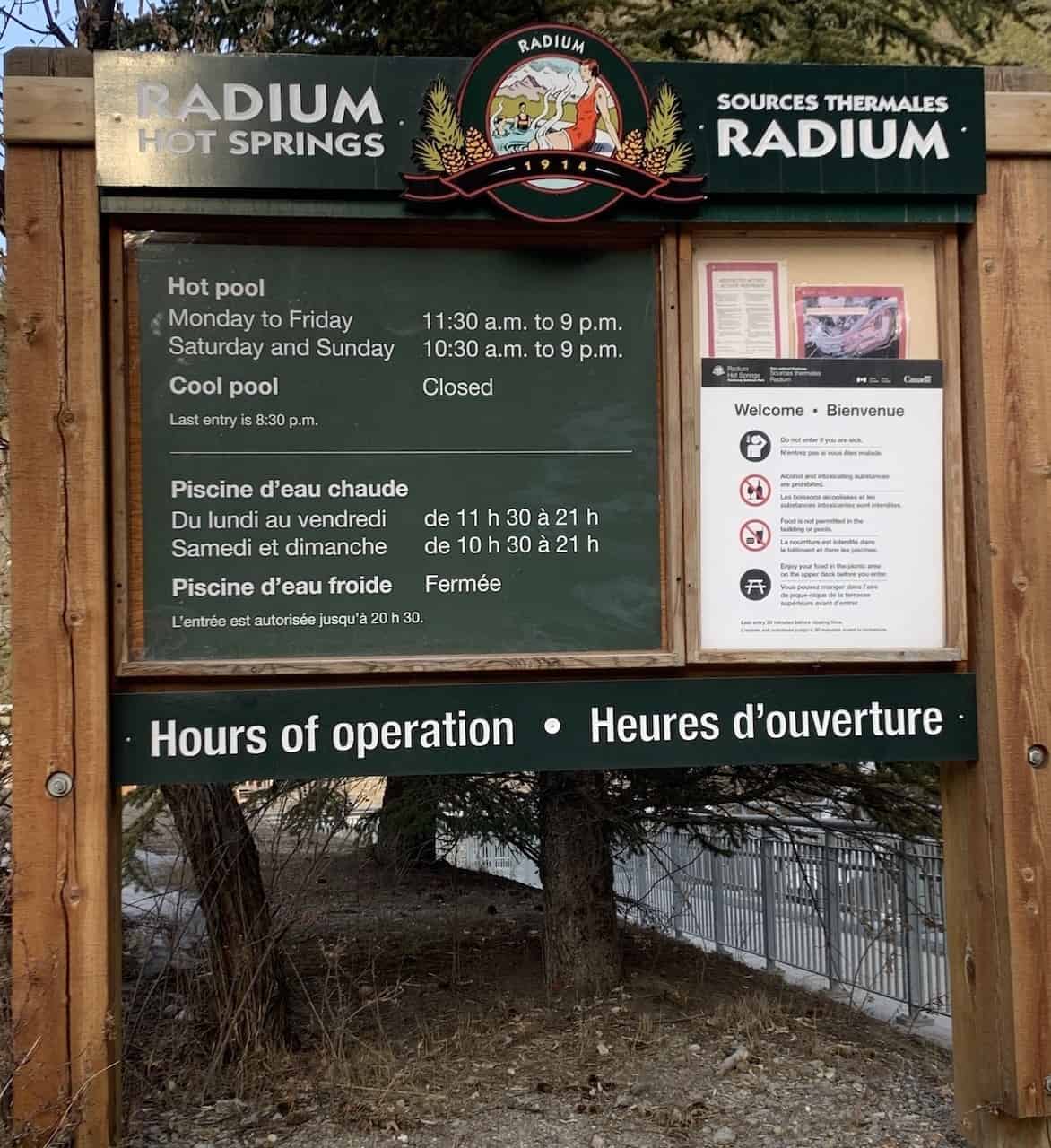 Visitor Information Sign at Radium Hot Springs British Columbia - Hours of operation and information is posted on a sign near the park entrance at Radium Hot Springs Pools in British Columbia, Canada.